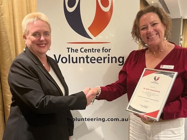 CEO Gemma Rygate presenting Linden Regina from St John Ambulance NSW with a certificate of accreditation as an Exemplary Volunteer Involving Organisation (EVIO).